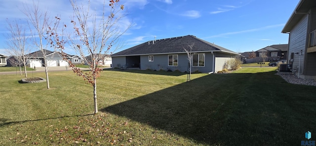 exterior space featuring cooling unit, a residential view, and a front yard