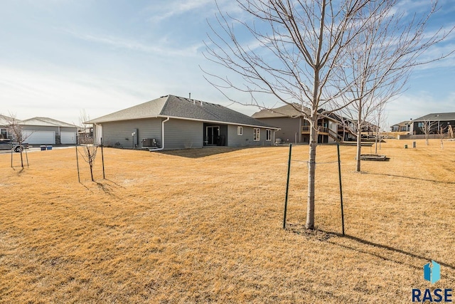 exterior space with a garage and central air condition unit