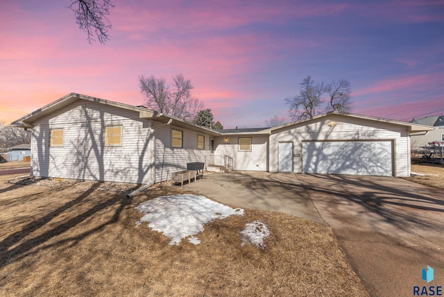 view of front of property featuring a garage and concrete driveway