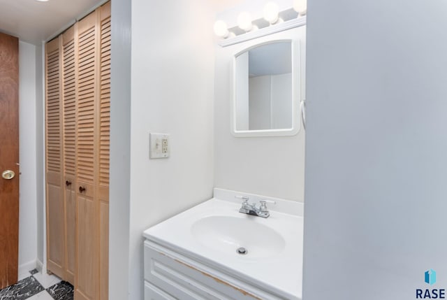 bathroom featuring a closet and vanity