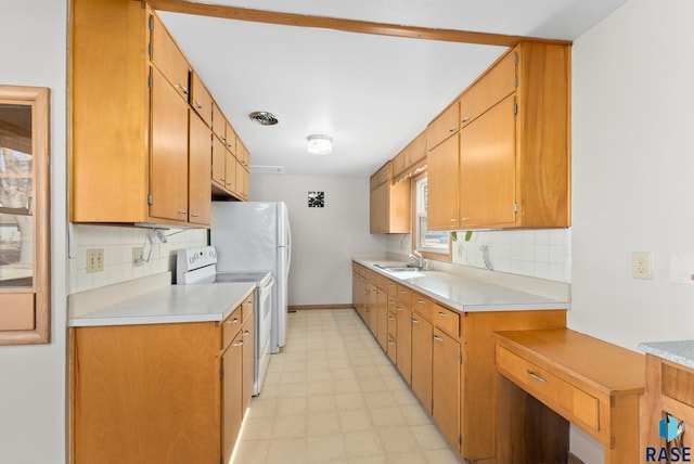 kitchen with brown cabinets, light countertops, white electric stove, and a sink