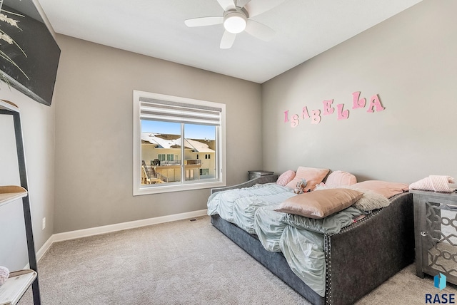 bedroom with light carpet, ceiling fan, visible vents, and baseboards