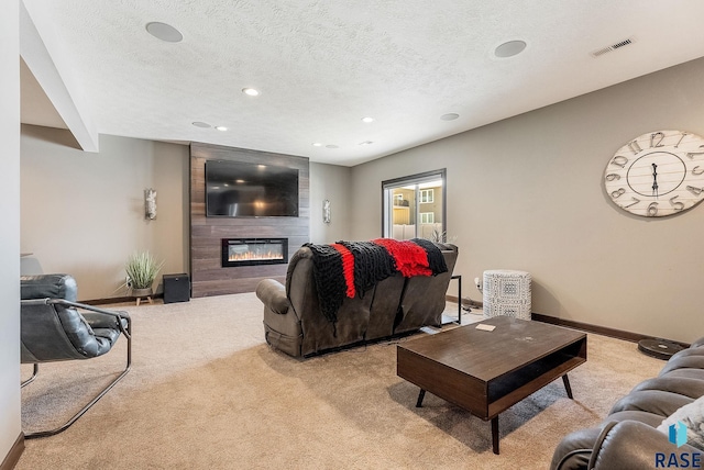 living area featuring a textured ceiling, light colored carpet, a fireplace, visible vents, and baseboards