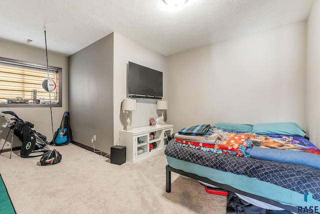 bedroom featuring carpet floors and a textured ceiling