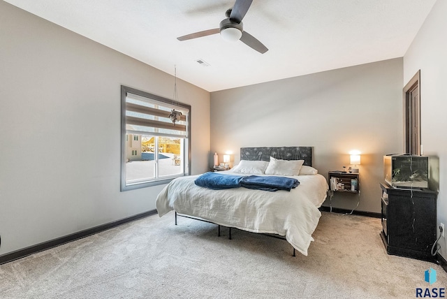 bedroom with baseboards, visible vents, a ceiling fan, and light colored carpet