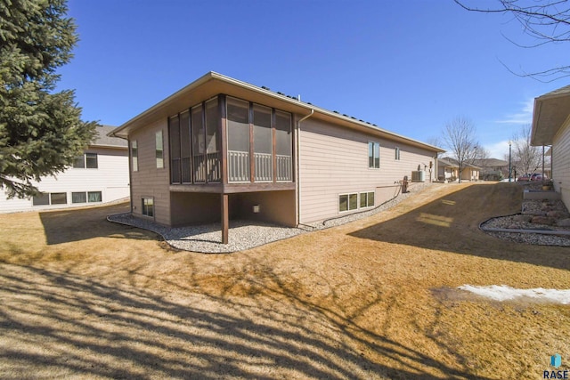 rear view of house featuring a sunroom