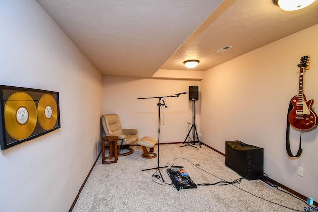 exercise area featuring light colored carpet, visible vents, and baseboards