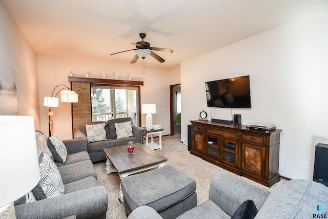 living area with a ceiling fan and light colored carpet