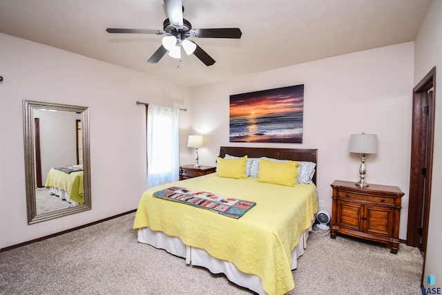 bedroom with light carpet, a ceiling fan, and baseboards