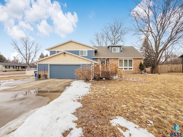 view of front of house with a garage, brick siding, a shingled roof, fence, and concrete driveway