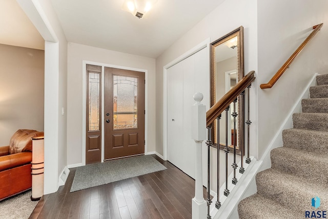 entryway featuring dark wood finished floors, stairway, and baseboards