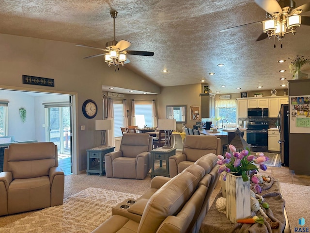 living area with lofted ceiling, light colored carpet, ceiling fan, and a textured ceiling