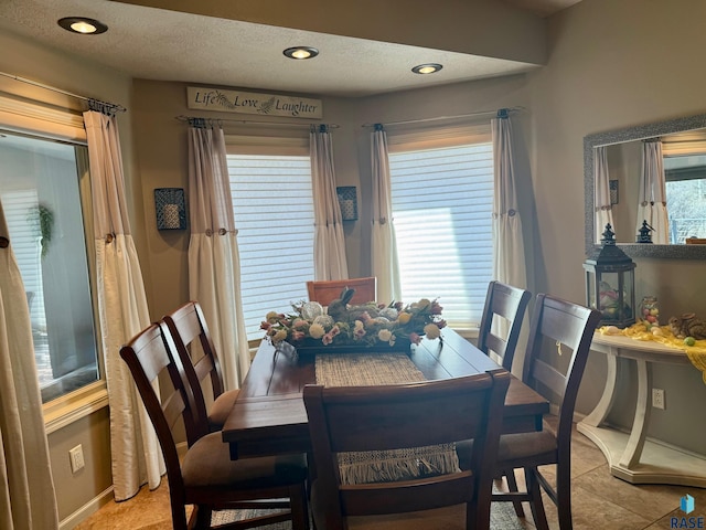 dining space featuring a healthy amount of sunlight, a textured ceiling, and recessed lighting