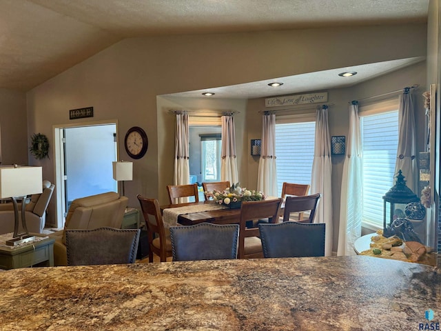 dining space featuring lofted ceiling