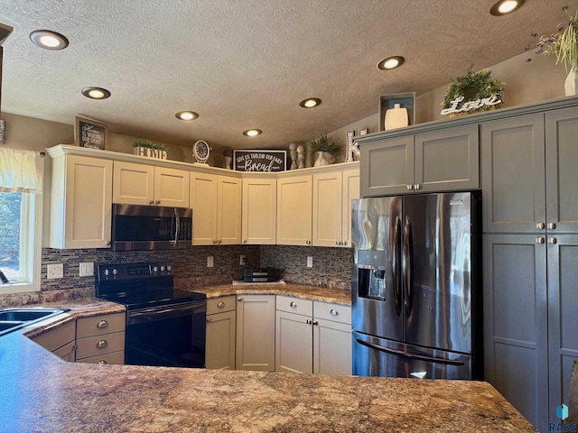 kitchen featuring appliances with stainless steel finishes, white cabinetry, a sink, and decorative backsplash