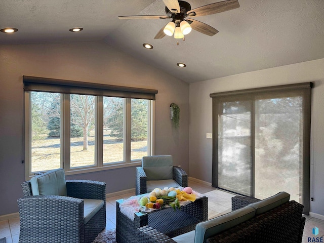 living area featuring light tile patterned floors, lofted ceiling, recessed lighting, ceiling fan, and a textured ceiling