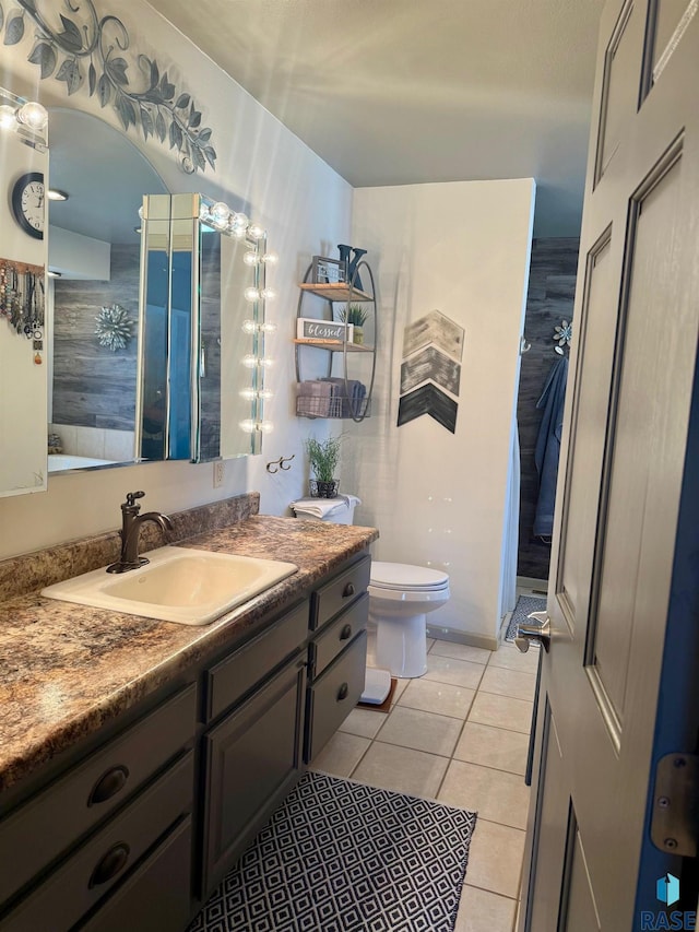 bathroom featuring vanity, toilet, and tile patterned floors