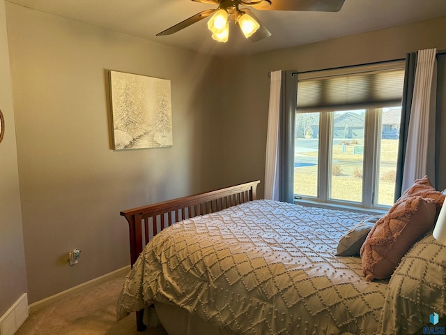 bedroom with carpet floors, visible vents, baseboards, and a ceiling fan