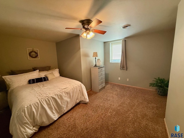 bedroom with carpet floors, ceiling fan, visible vents, and baseboards