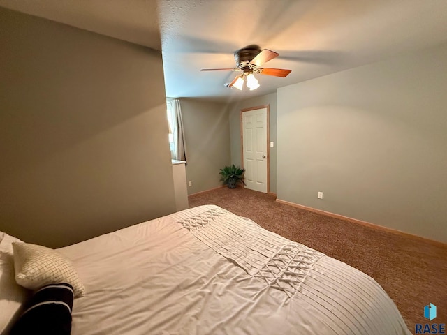 unfurnished bedroom with ceiling fan, carpet floors, and baseboards