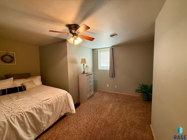 bedroom with carpet floors, visible vents, ceiling fan, and baseboards