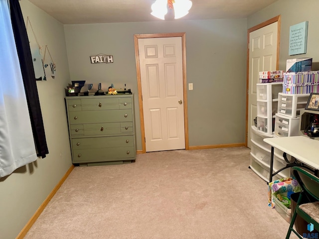 interior space with light carpet and baseboards