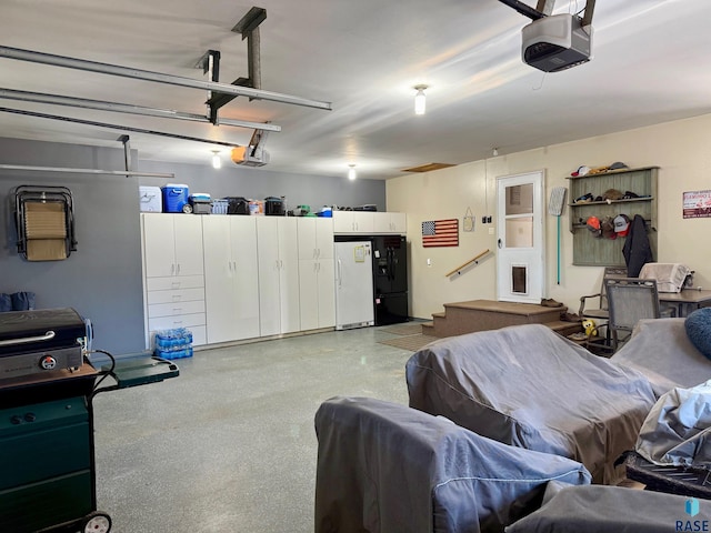 garage featuring a garage door opener and freestanding refrigerator