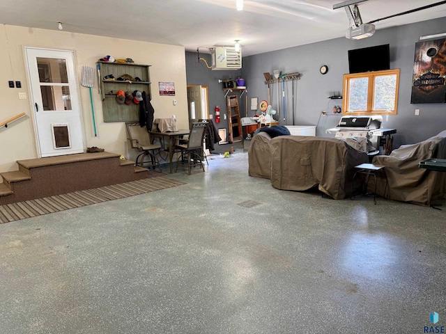 living area with a garage and speckled floor