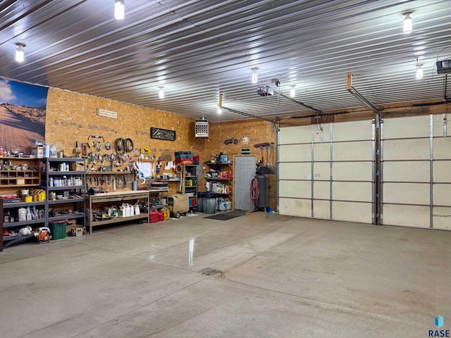 garage featuring a garage door opener and a workshop area