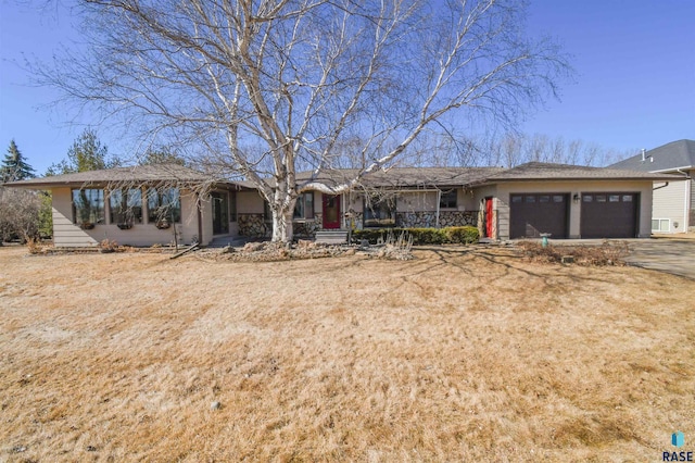 single story home featuring a garage and driveway