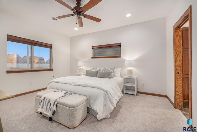 bedroom with light carpet, recessed lighting, and baseboards