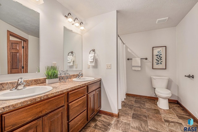 full bath with visible vents, a sink, toilet, and double vanity