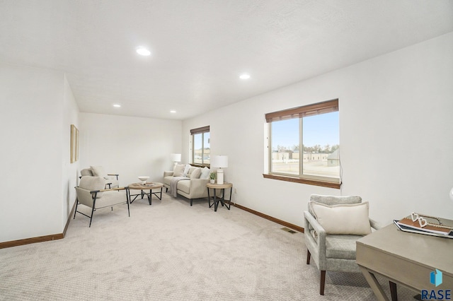 living area featuring recessed lighting, light carpet, visible vents, and baseboards