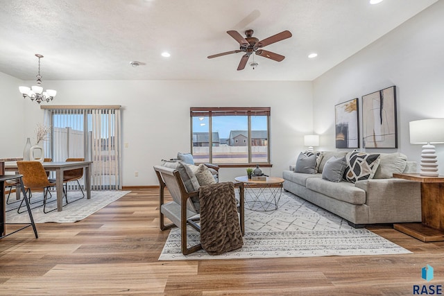 living room featuring light wood-type flooring, baseboards, and a wealth of natural light