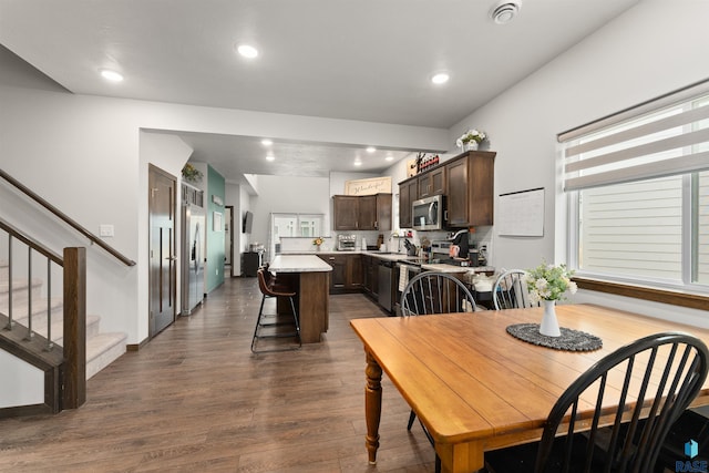 dining room featuring stairs, baseboards, dark wood finished floors, and recessed lighting