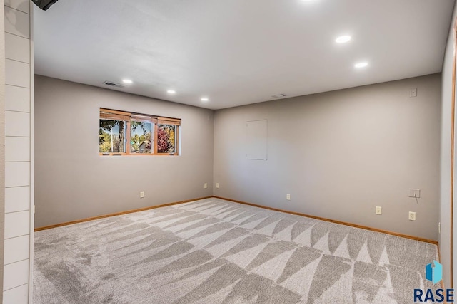 unfurnished room with carpet floors, recessed lighting, visible vents, and baseboards