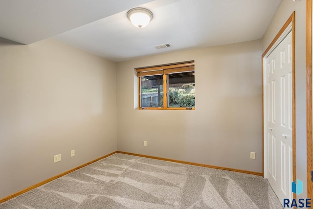 unfurnished bedroom featuring a closet, carpet flooring, visible vents, and baseboards