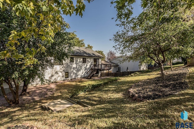 view of yard featuring a deck and stairs