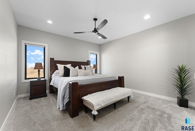 bedroom featuring a ceiling fan, recessed lighting, light colored carpet, and baseboards