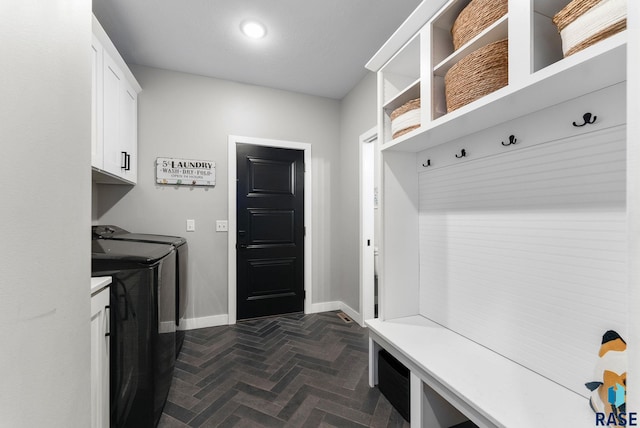 mudroom featuring brick floor, independent washer and dryer, and baseboards