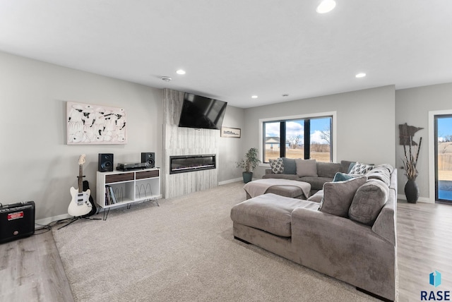 living room with recessed lighting, a fireplace, and baseboards