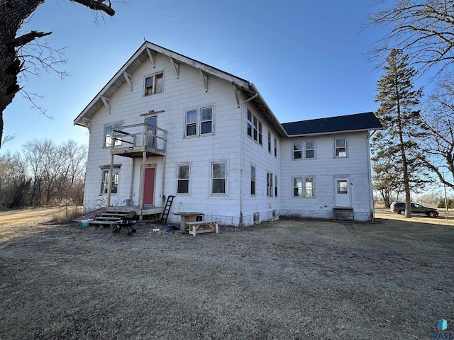 rear view of property featuring a balcony and central AC unit