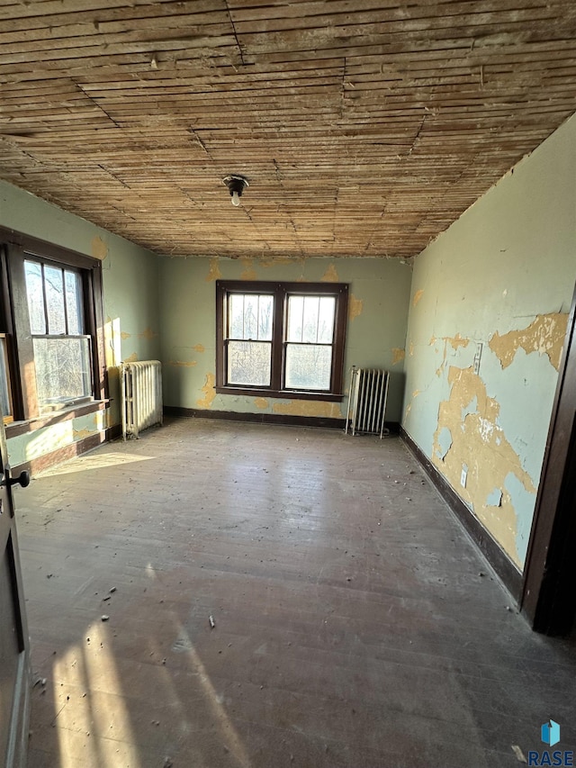 misc room with wooden ceiling, plenty of natural light, and radiator heating unit