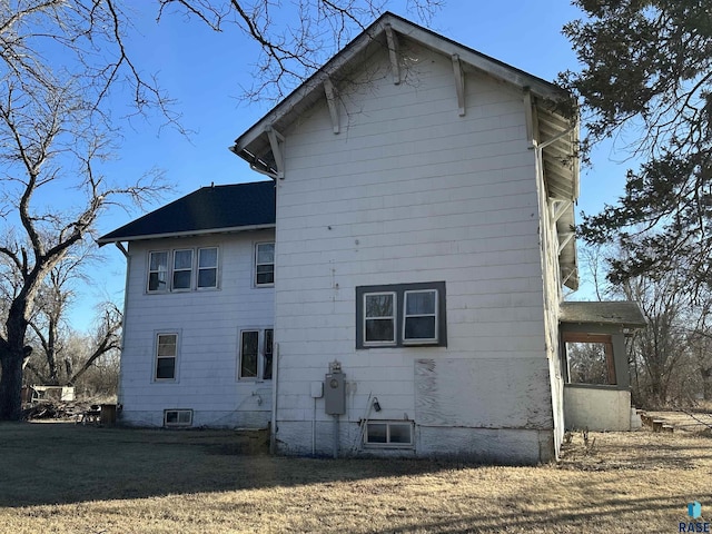 view of property exterior with a lawn