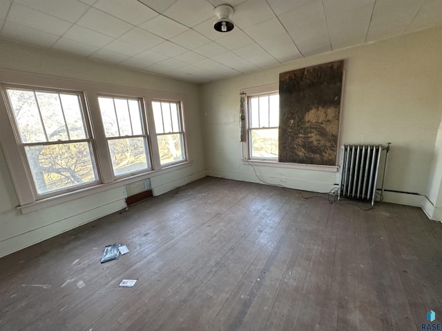 unfurnished room with wood-type flooring and radiator