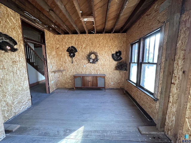 interior space featuring beamed ceiling, wood finished floors, and wood ceiling