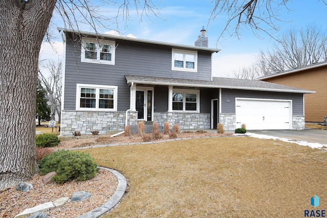 traditional-style house featuring an attached garage, stone siding, driveway, and a chimney