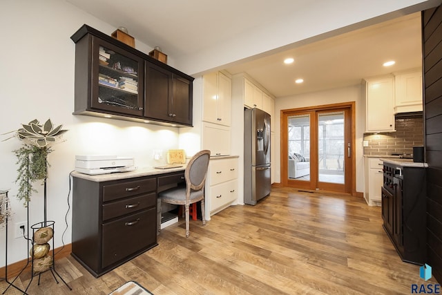 office featuring light wood-type flooring, baseboards, built in study area, and recessed lighting