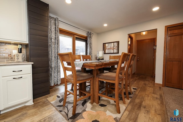 dining area with light wood-type flooring and recessed lighting