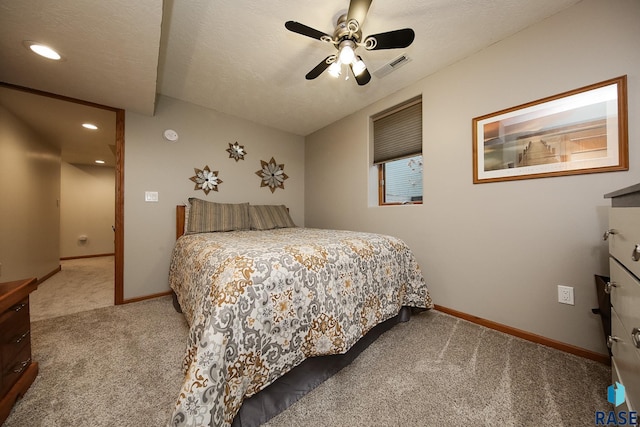 carpeted bedroom with visible vents, ceiling fan, a textured ceiling, and baseboards